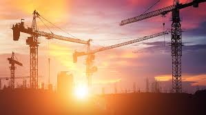 Construction cranes at sunset representing Infrastructure Development
